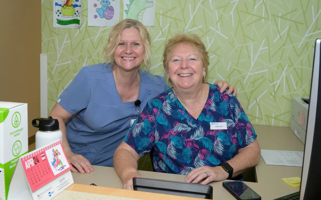 two receptionists smiling